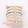Pulsera ajustable de acero variada con cruz