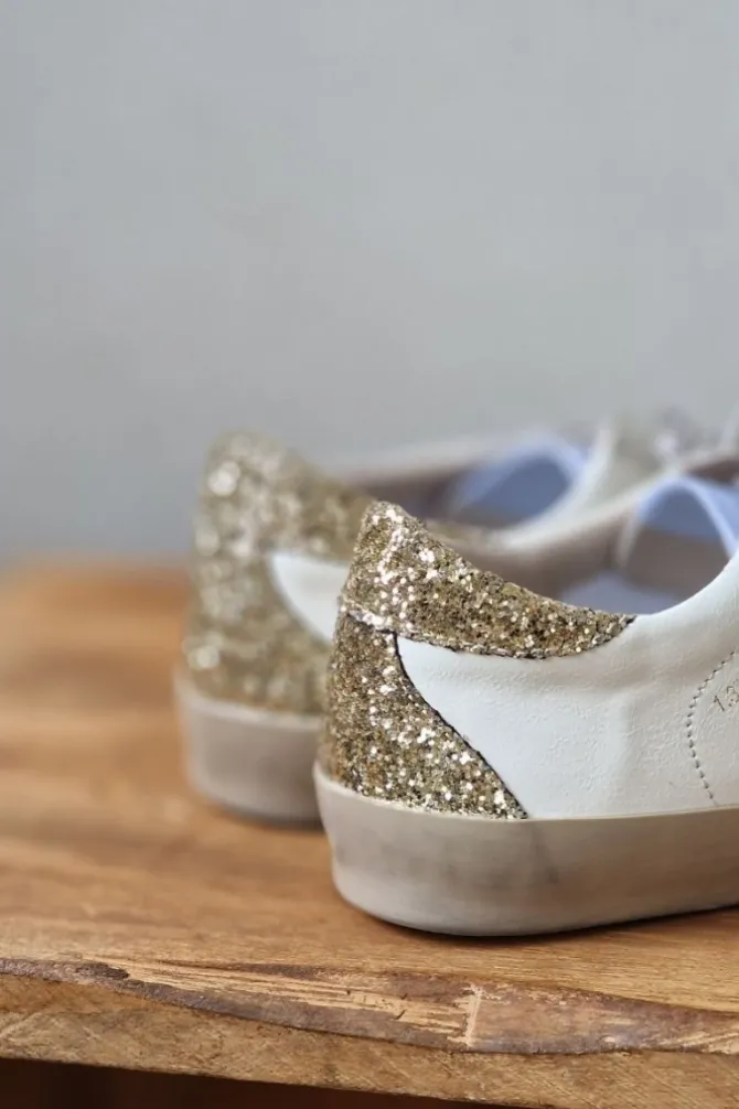 Sneakers blancas con detalles dorado