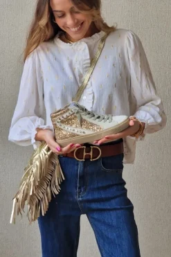 Sneakers dorada con detalle blanco, glitter y tachuelas