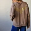 Sudadera básica con águila dorada topo